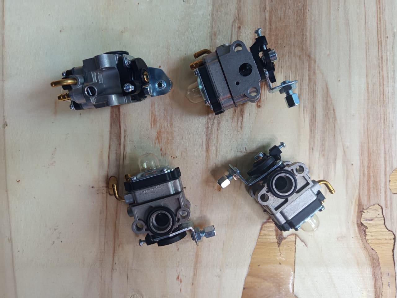 Brush cutter carburettors laid out on the counter