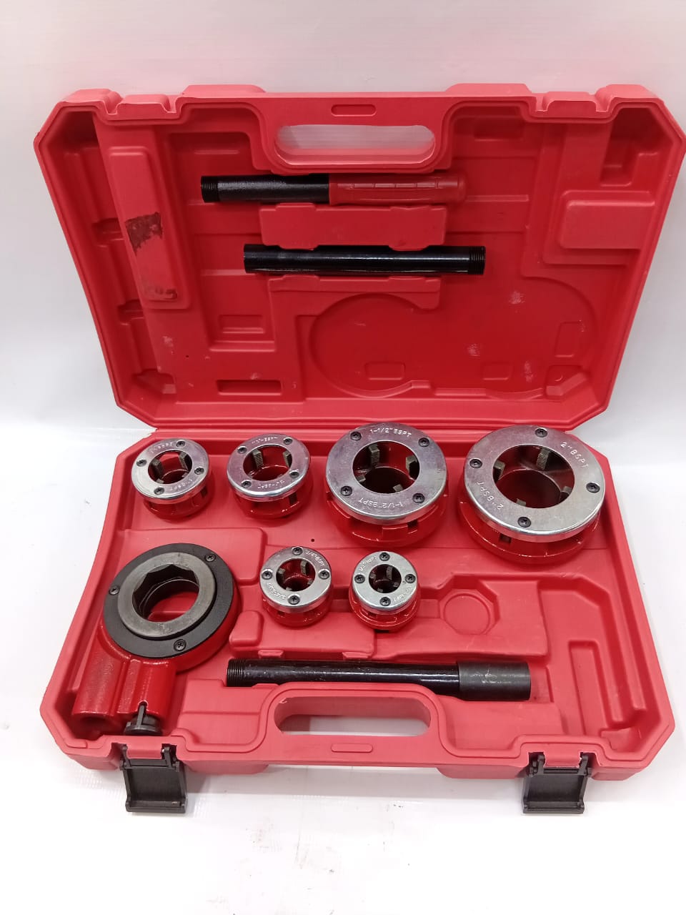 A pipe threading set open in its case on the workbench